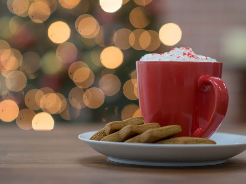 Cup of hot chocolate and a plate of Christmas cookies